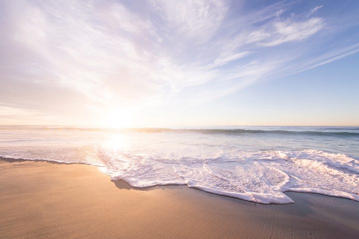 Sunrise above a sandy beach.